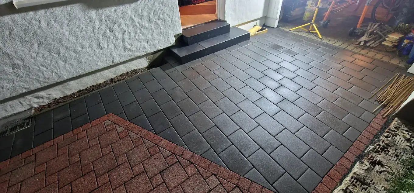 Geschwungene Einfahrt aus dunklem Pflaster